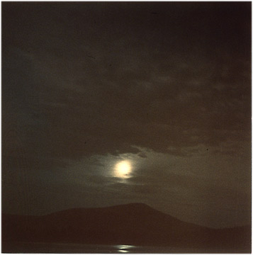 Photograph was taken at vight and glows with a reflection in the pond over a mountain in Baxter Park-a large wilderness area in Northern Maine